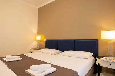 a bedroom with a large bed with two towels on it at Relais central Turati in Rome