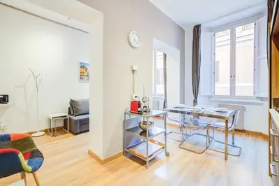 a living room with a table and a couch at GuestHost - Spanish Steps Luxury Apartment in Rome