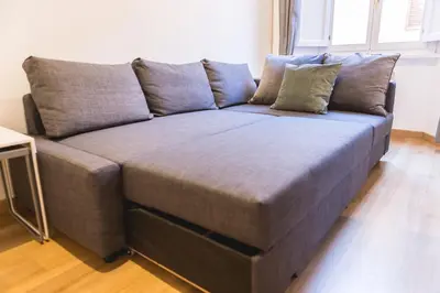 a large gray couch in a living room at GuestHost - Spanish Steps Luxury Apartment in Rome