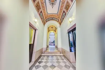 a hallway in a building with a ceiling at GuestHost - Spanish Steps Luxury Apartment in Rome