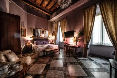 a living room with a bed and a couch at Navona Grand Suite in Rome
