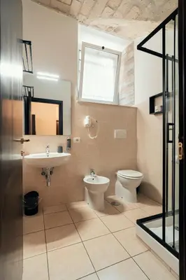 a bathroom with a sink and a toilet and a window at Saint Peter Loft in Rome