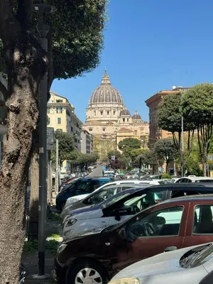 a bunch of cars parked in a parking lot with a building at Saint Peter Loft in Rome