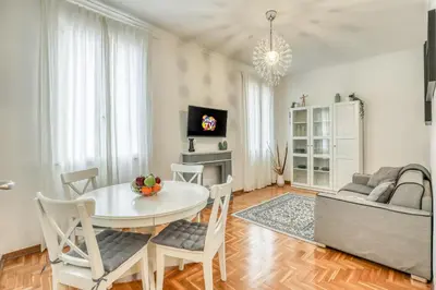 a living room with a table and a couch at ATRHOME penthouse Frattina in Rome