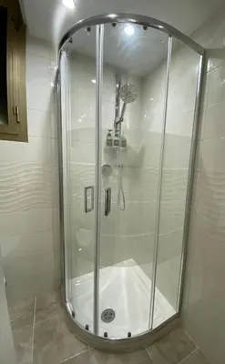 a shower with a glass door in a bathroom at New studio a Trastevere in Rome