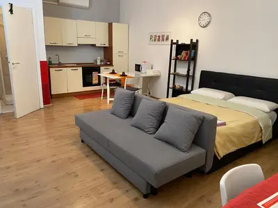 a living room with a couch and a bed at New studio a Trastevere in Rome