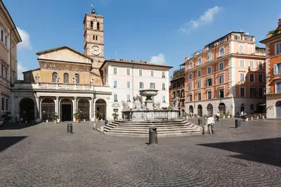 a city square with a fountain and a clock tower at New studio a Trastevere in Rome