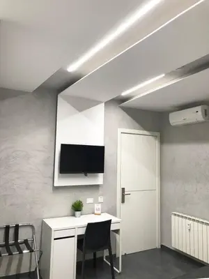 a room with a desk and a tv on the wall at Le Vie del Vaticano in Rome