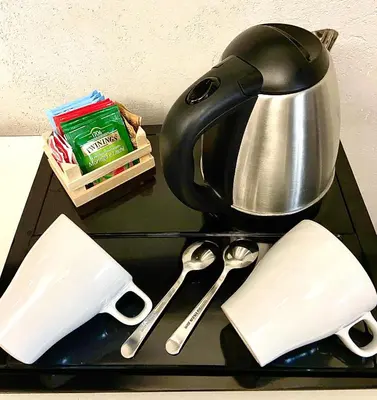 a tea kettle and spoons on a tray at Le Vie del Vaticano in Rome