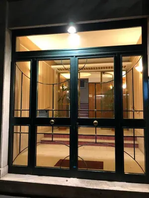 a glass door of a building with a bench inside at Le Vie del Vaticano in Rome