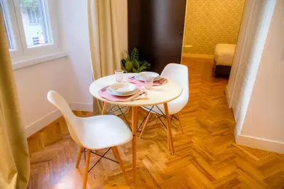 a table with two chairs and a plate on it at App Beccaria Apartments in Rome in Rome