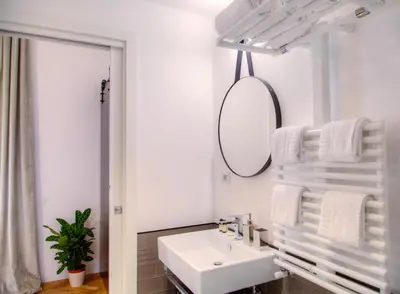 a white bathroom with a sink and a mirror at App Beccaria Apartments in Rome in Rome