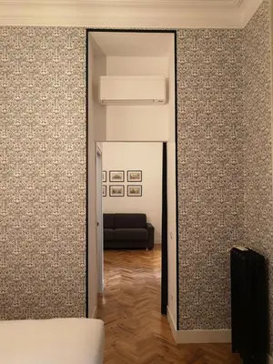 a room with a mirror and a couch at App Beccaria Apartments in Rome in Rome