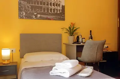 a hotel room with a bed with towels on it at Porta Pia Comfy Rooms in Rome