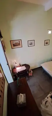 a living room with a bed and a table at your Rome basic but bonnie corner in Rome