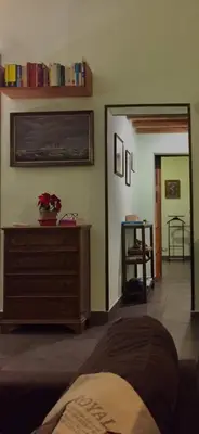 a living room with a dresser and a room with aumbledore at your Rome basic but bonnie corner in Rome