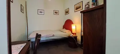 a small bedroom with a small bed and a lamp at your Rome basic but bonnie corner in Rome