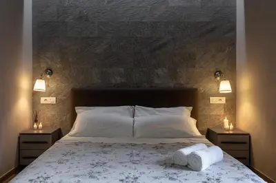 a bedroom with a large bed with two night stands at City Break Nomentana in Rome