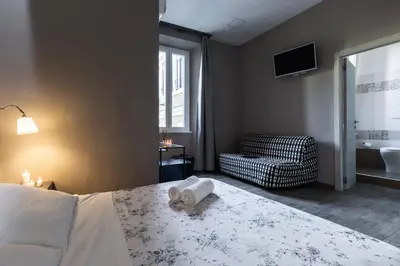 a bedroom with a bed with a towel on it at City Break Nomentana in Rome