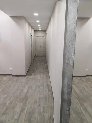 an empty hallway with white walls and wooden floors at City Break Nomentana in Rome