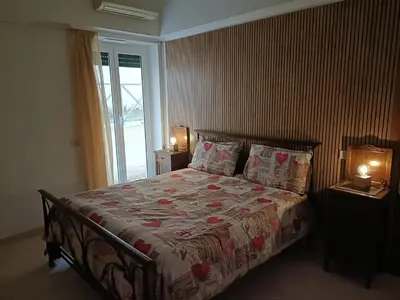a bedroom with a bed with two lamps and a window at City Break Nomentana in Rome