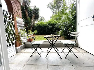 two chairs and a table on a patio at Garden Rooms by Casa Proto in Rome