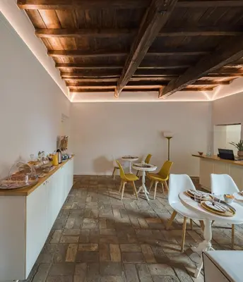a kitchen and dining room with tables and chairs at Palazzo Lupardi Relais in Rome