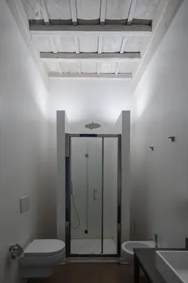a bathroom with a toilet and a glass shower at Palazzo Lupardi Relais in Rome