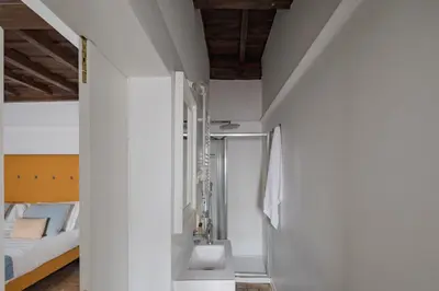 a bathroom with a shower in the corner of a room at Palazzo Lupardi Relais in Rome