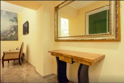 a room with a table and a mirror on the wall at VIA VENETO SUITE 107 in Rome