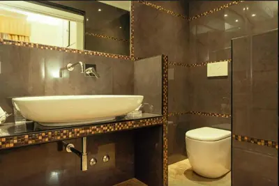 a bathroom with a sink and a toilet at VIA VENETO SUITE 107 in Rome