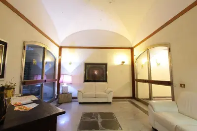 a living room with a couch and a chair at VIA VENETO SUITE 107 in Rome