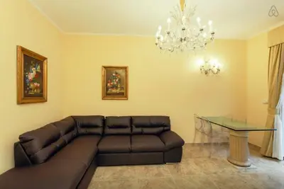 a living room with a couch and a glass table at VIA VENETO SUITE 107 in Rome