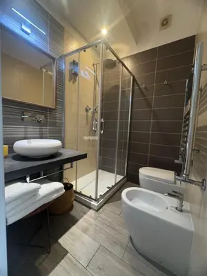 a bedroom with a bed and a table and a chair at Stileroma in Rome