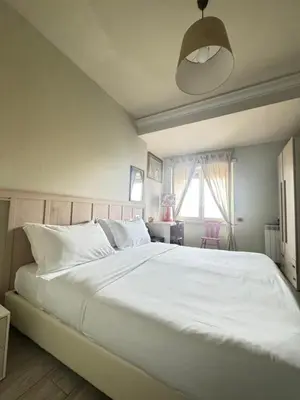 a bedroom with a large white bed and a window at Stileroma in Rome