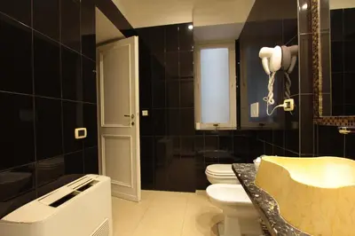 a bathroom with a toilet and a sink at VIA VENETO SUITE 104 in Rome
