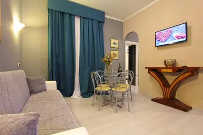a living room with a couch and a table at VIA VENETO SUITE 104 in Rome