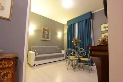 a living room with a couch and a table at VIA VENETO SUITE 104 in Rome