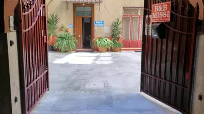 an entrance to a building with a gate with abid interest sign at B&B Missi in Rome