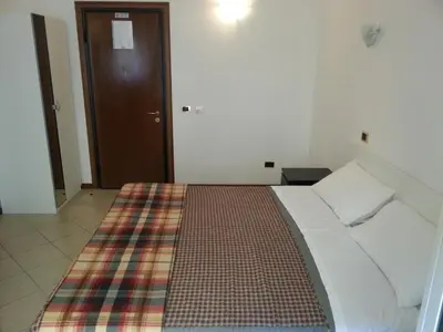 a bedroom with a bed with a plaid blanket at B&B Missi in Rome