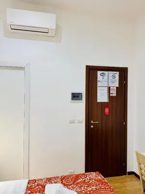 a room with a wooden door and a room with a bed at Tawhid Accomodation in Rome