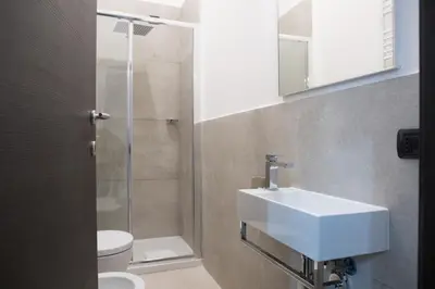 a bathroom with a sink and a shower at Bespoke Roma Suites in Rome