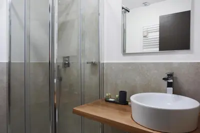 a bathroom with a sink and a shower at Bespoke Roma Suites in Rome
