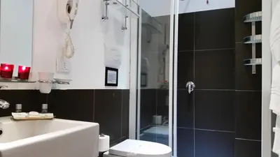 a bathroom with a shower and a toilet and a sink at InnVatican Guest House in Rome