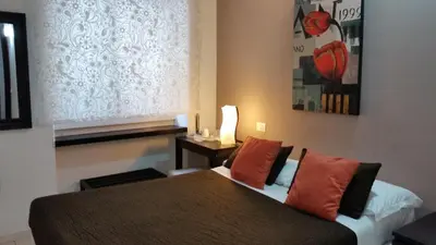 a hotel room with two beds and a table and a bed at InnVatican Guest House in Rome