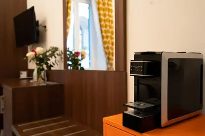 a tv sitting on top of a wooden table next to a tvicterictericter at Archi di Roma Guest House in Rome