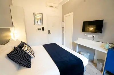 a bedroom with a bed with two pillows on it at Archi di Roma Guest House in Rome