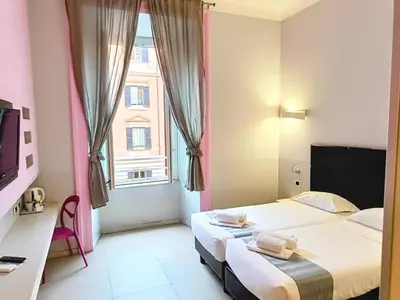 a hotel room with two beds and a window at Manin Suites LT in Rome