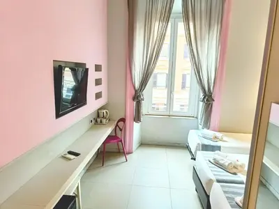 a small room with pink walls and a mirror at Manin Suites LT in Rome