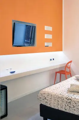 a room with a bed and a tv on a wall at Manin Suites LT in Rome